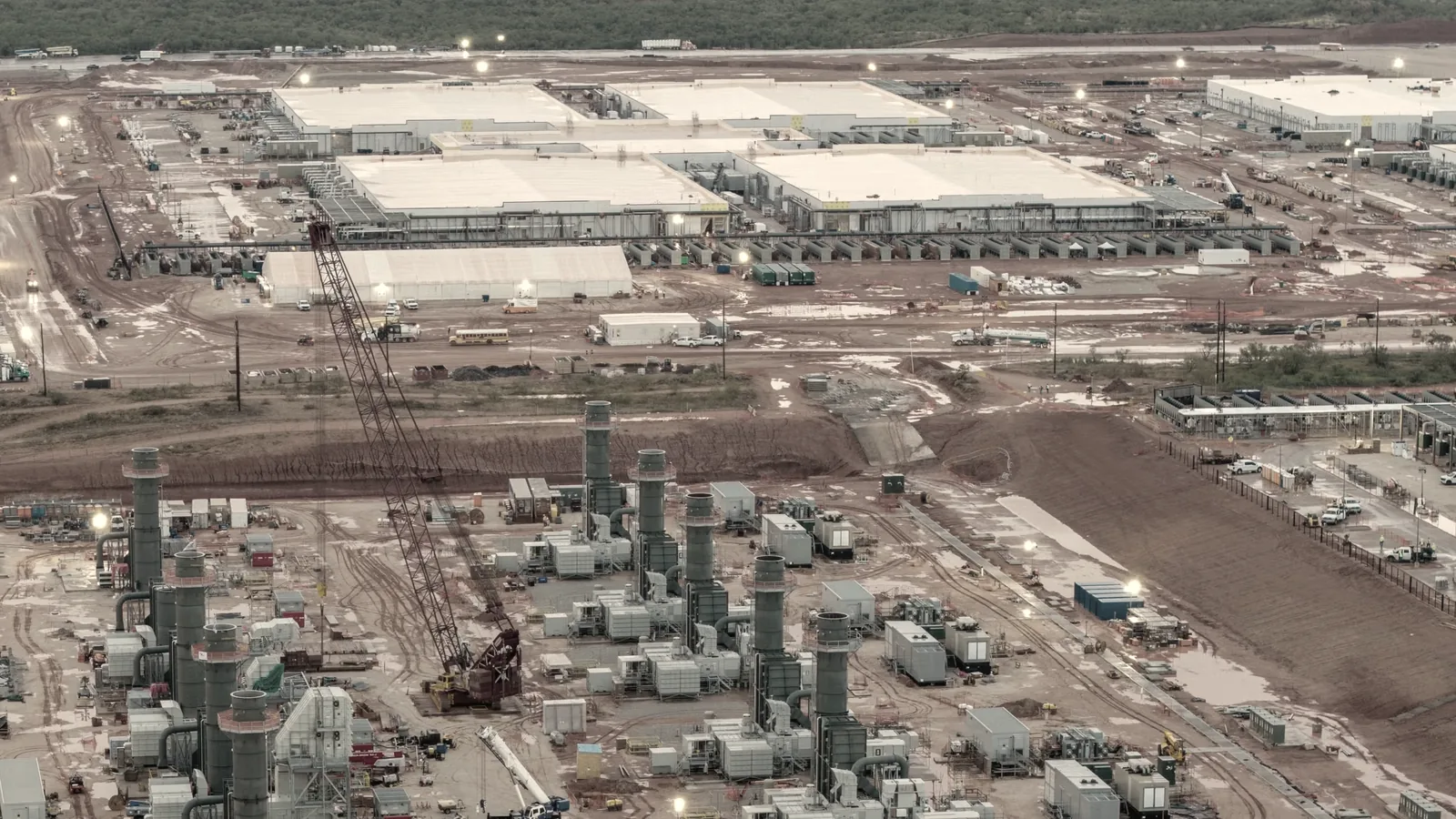Aerial view of a hyperscale data center campus with a field of gas turbine generators installed in the foreground.